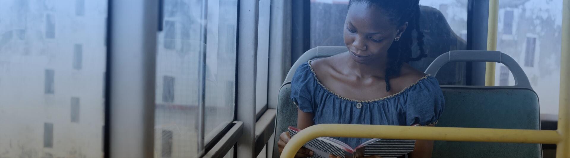 Woman Reading on Public Transport